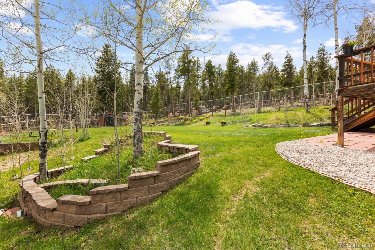 8600 South Warhawk Road Conifer, CO 80433 - Photo 4 of 50 a view of a garden with a fountain