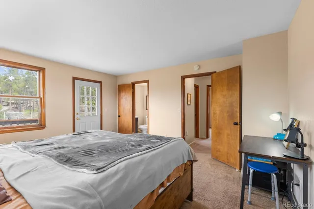 a bedroom with a bed and a table in it