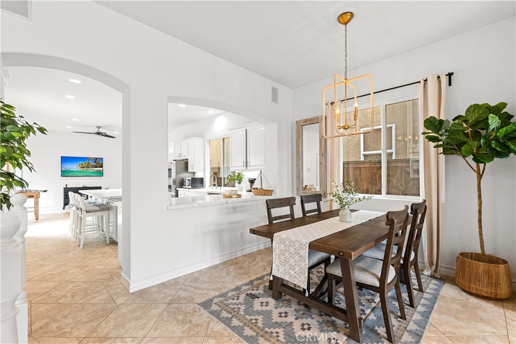 513 Pecan Avenue Huntington Beach, CA 92648 - Photo 11 of 46 a view of a dining room and livingroom with furniture wooden floor a chandelier