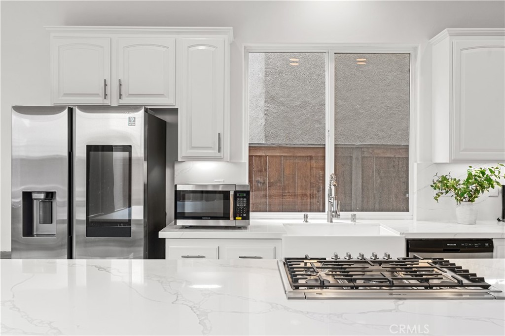 513 Pecan Avenue Huntington Beach, CA 92648 - Photo 12 of 46 a kitchen with stainless steel appliances granite countertop a stove a sink and a refrigerator