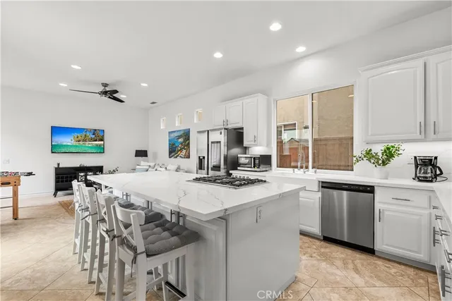 a kitchen with stainless steel appliances kitchen island granite countertop a sink and cabinets