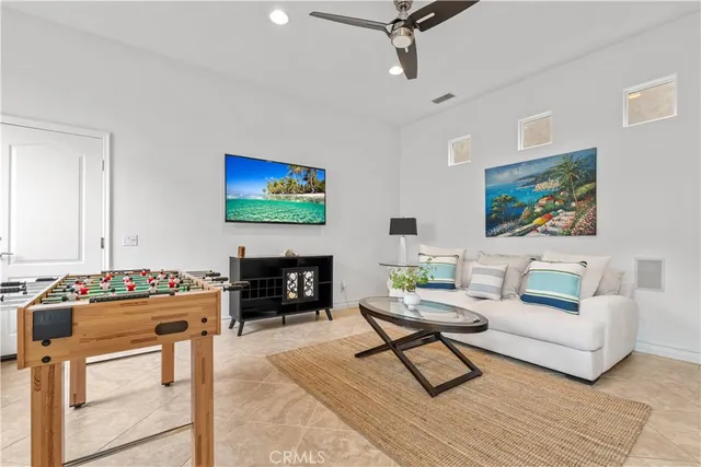 a living room with furniture a rug and a flat screen tv
