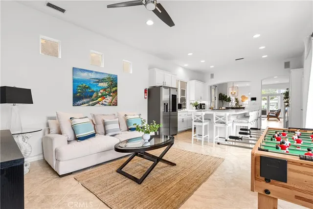 a living room with furniture and kitchen view