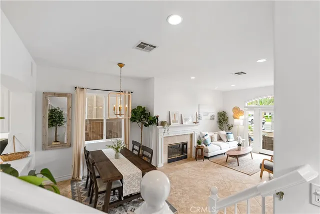 a living room with furniture a fireplace and a floor to ceiling window