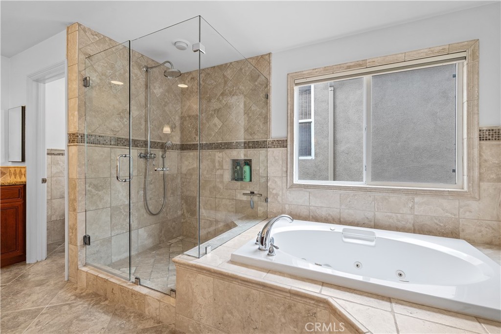 513 Pecan Avenue Huntington Beach, CA 92648 - Photo 28 of 46 a bathroom with a tub a sink and a shower