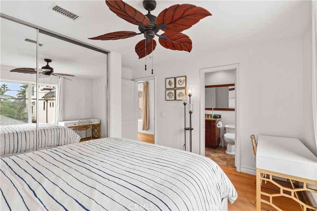 513 Pecan Avenue Huntington Beach, CA 92648 - Photo 36 of 46 a bedroom with bed and a chandelier