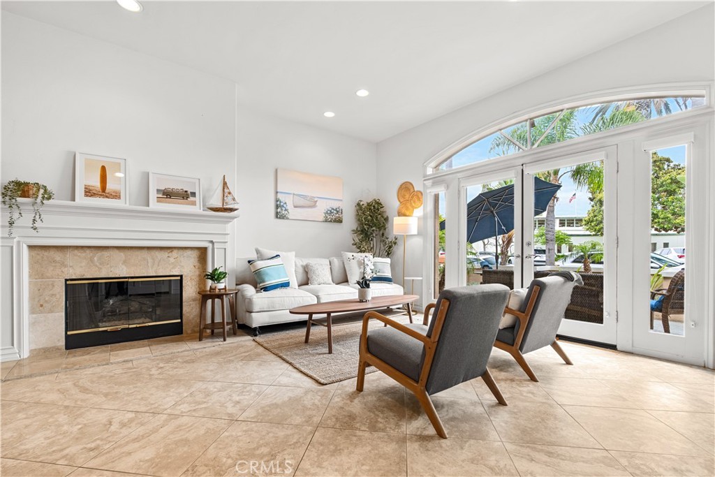 513 Pecan Avenue Huntington Beach, CA 92648 - Photo 8 of 46 a living room with furniture a large window and a fireplace