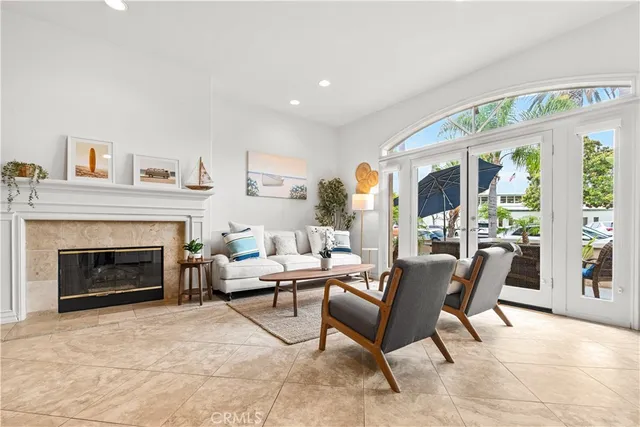 a living room with furniture a large window and a fireplace