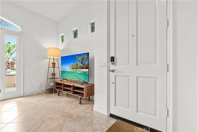 an empty room with furniture and flat screen tv