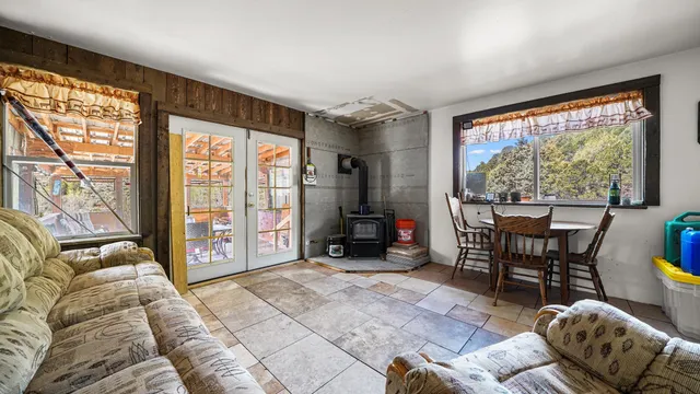 a living room with furniture a flat screen tv and a window