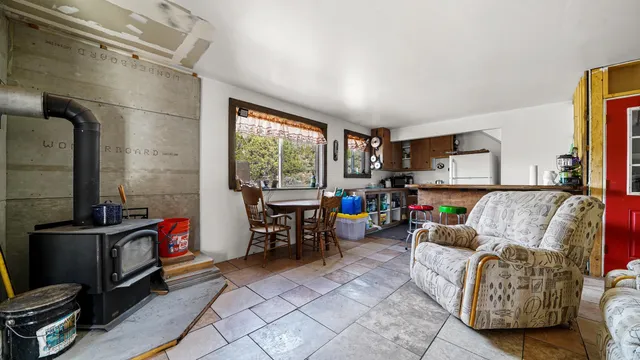 a utility room with lots of wooden furniture and a large window
