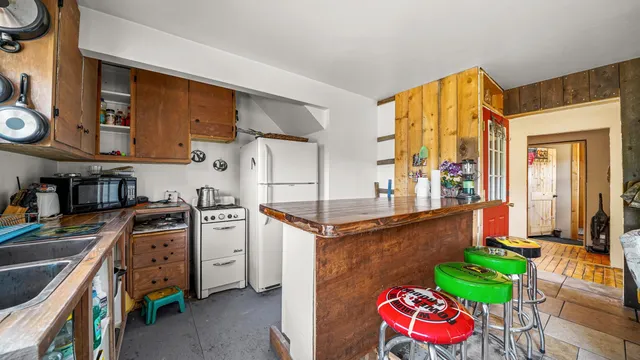 an aerial view of house with yard and mountain view in back