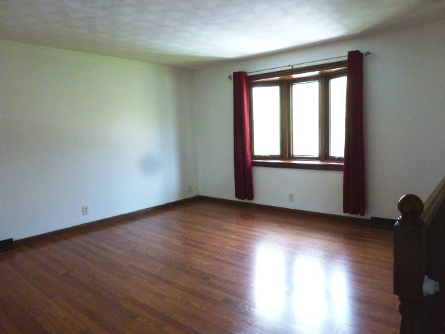 1026 Highway 10 Clinton, IL 61727 - Photo 2 of 20 an empty room with wooden floor and windows