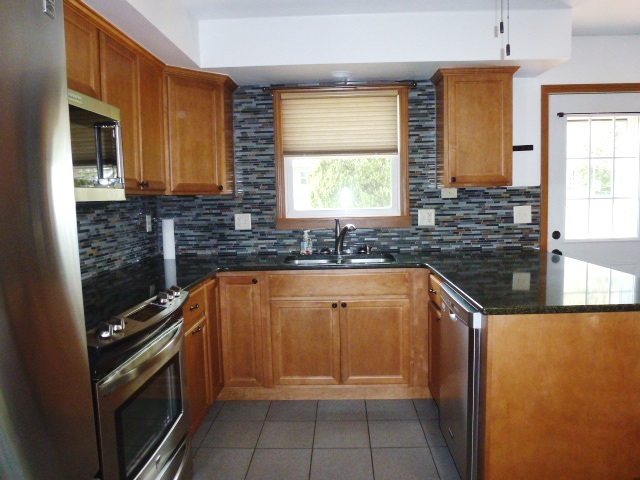 1026 Highway 10 Clinton, IL 61727 - Photo 5 of 20 a kitchen with granite countertop a sink and a stove