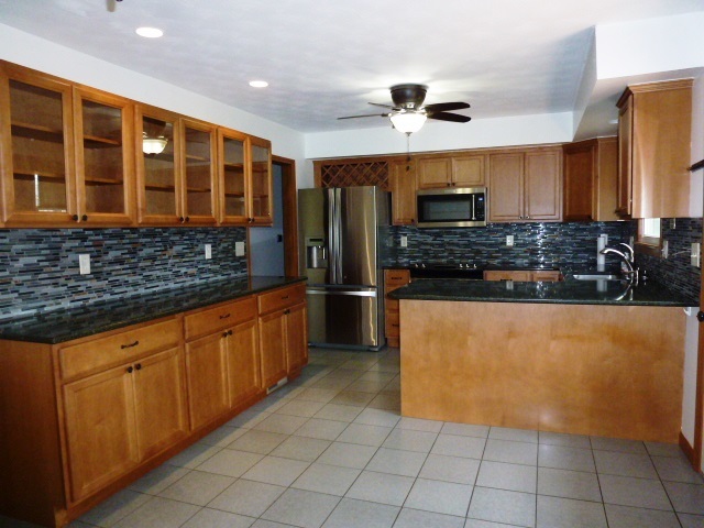 1026 Highway 10 Clinton, IL 61727 - Photo 6 of 20 a kitchen with stainless steel appliances granite countertop a refrigerator and a sink