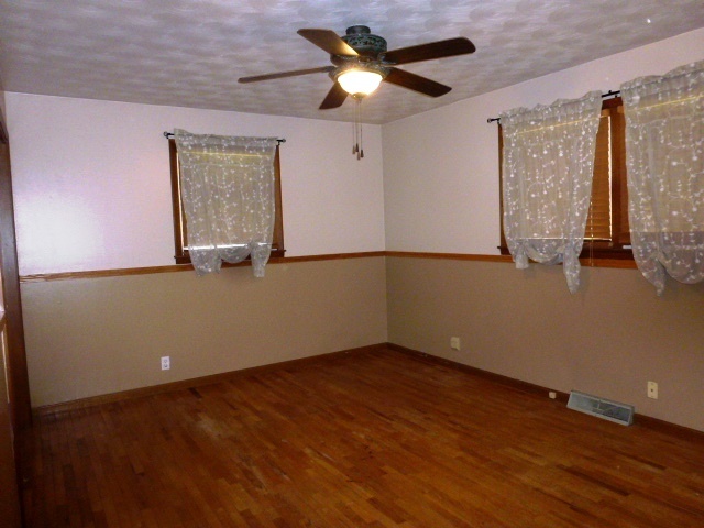 1026 Highway 10 Clinton, IL 61727 - Photo 8 of 20 a view of an empty room with window and wooden floor
