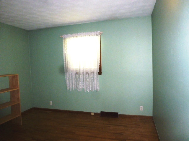 1026 Highway 10 Clinton, IL 61727 - Photo 9 of 20 a view of an empty room with wooden floor and a window