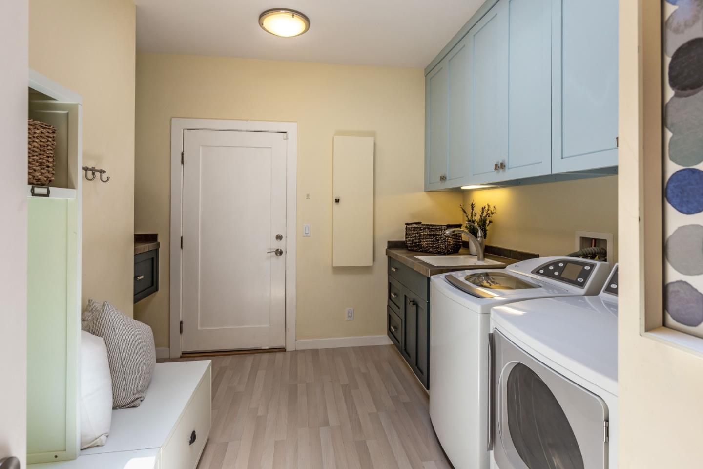 166 Sausal Drive Portola Valley, CA 94028 - Photo 24 of 26 a view of washer and dryer with kitchen in the background