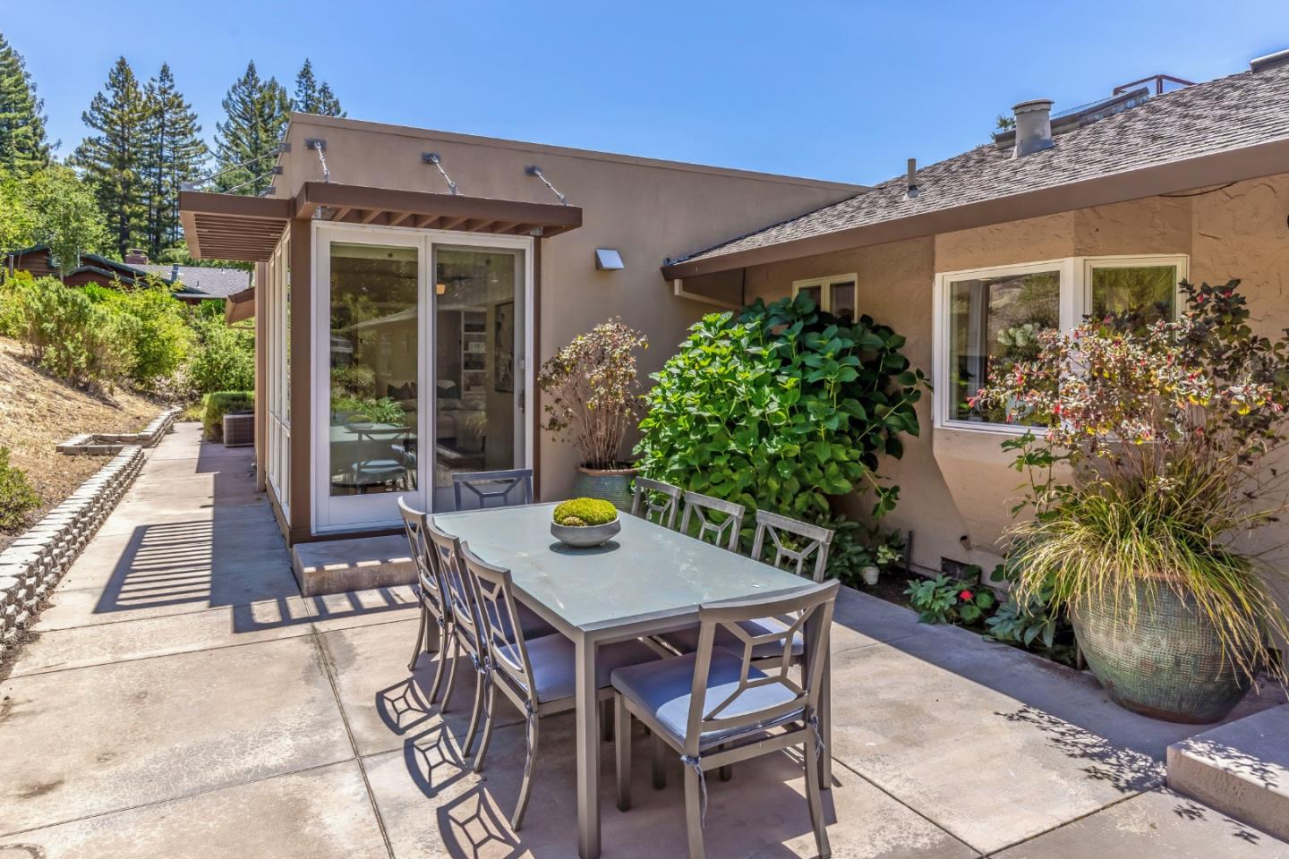 166 Sausal Drive Portola Valley, CA 94028 - Photo 25 of 26 a view of a backyard with table and chairs and potted plants