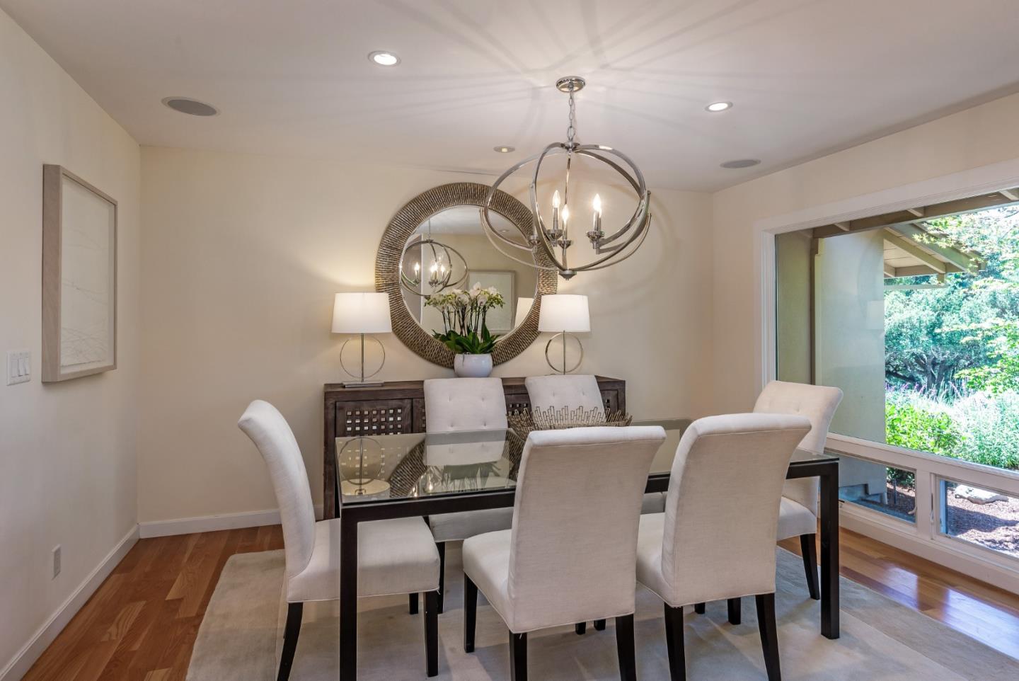 166 Sausal Drive Portola Valley, CA 94028 - Photo 7 of 26 a view of a dining room with furniture a chandelier and wooden floor