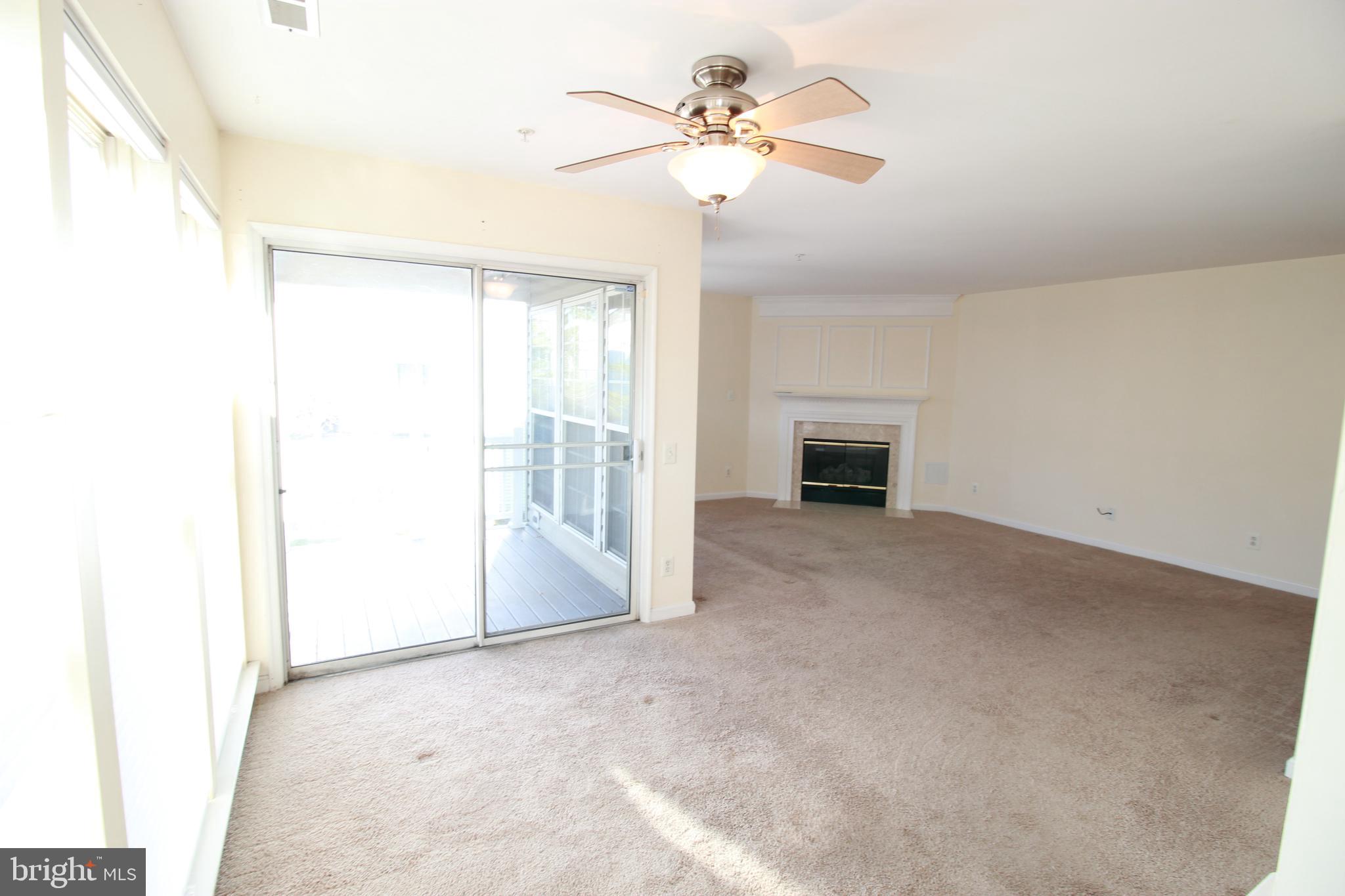 249 Rosebay Court Delran, NJ 08075 - Photo 6 of 16 a view of a livingroom with a ceiling fan and window