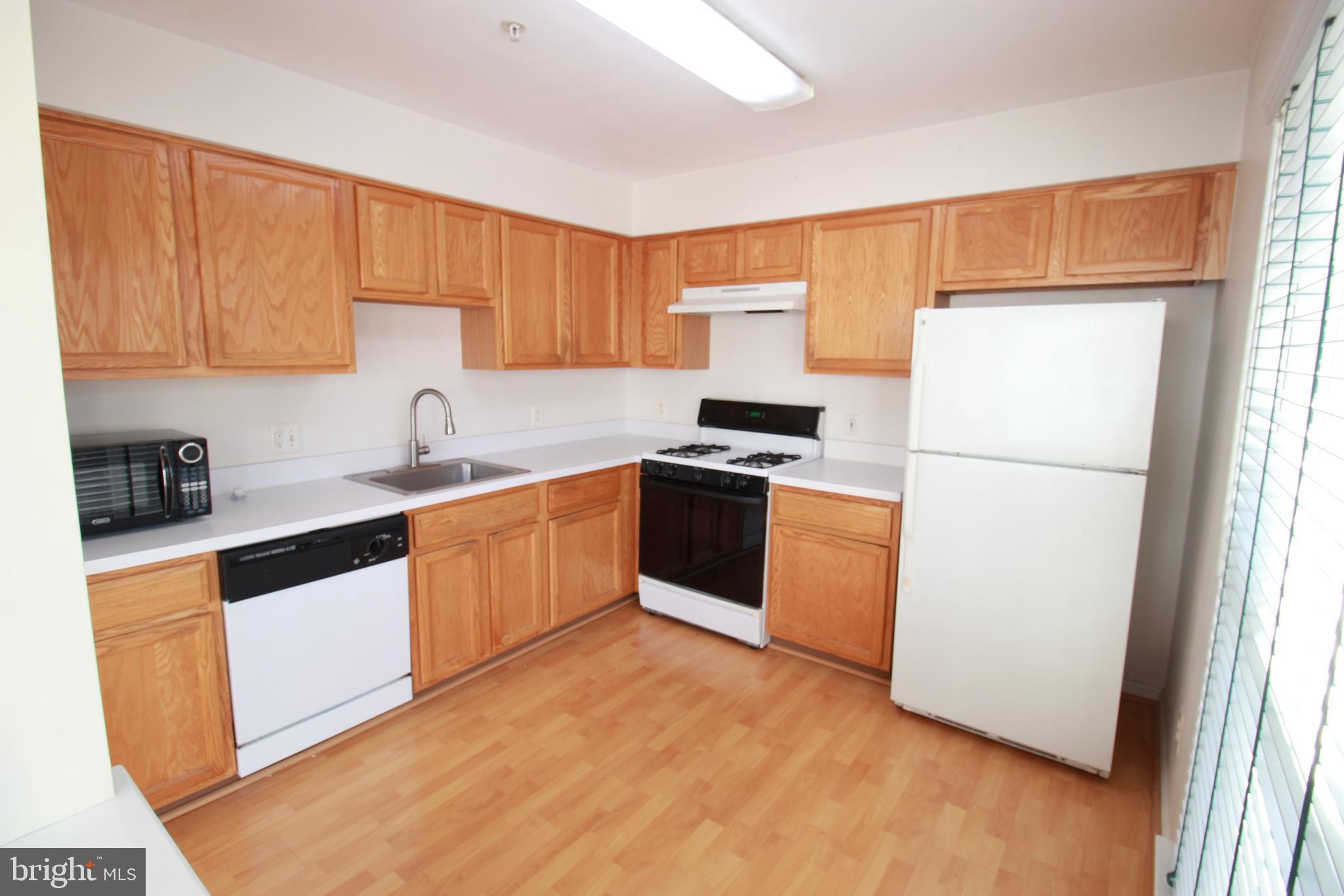 249 Rosebay Court Delran, NJ 08075 - Photo 7 of 16 a kitchen with a refrigerator sink and cabinets