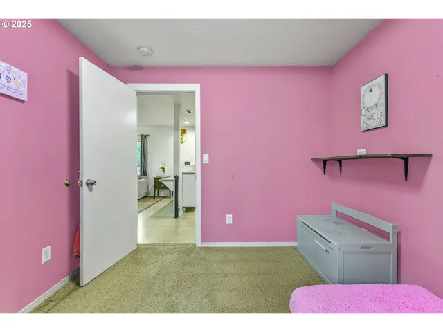 a bedroom with pink walls