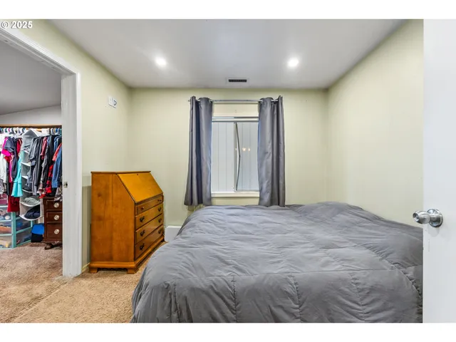 a bedroom with a bed and a dresser