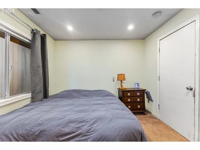 a bedroom with a bed and a dresser