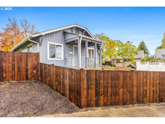 a front view of a house with wooden fence