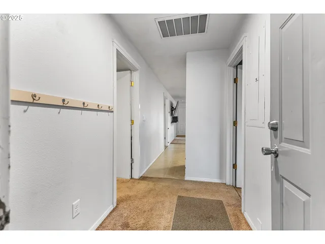 a view of a house with a wooden fence