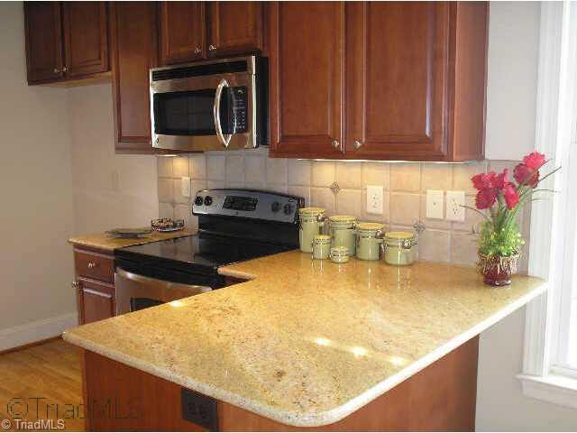 44 The Bluffs Rural Hall, NC 27045 - Photo 4 of 9 Other. Kitchen offers gorgeous granite countertops, warm-colored cabinetry, tile backsplash & stainless steel appliances!
