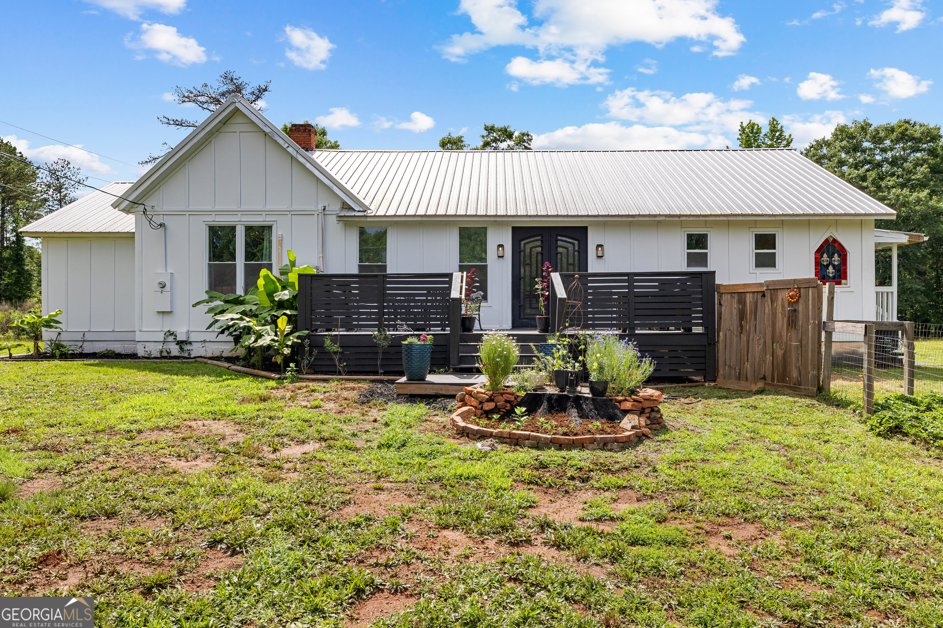 1329 Standing Rock Road Senoia, GA 30276 - Photo 76 of 77 a front view of house with a garden and patio