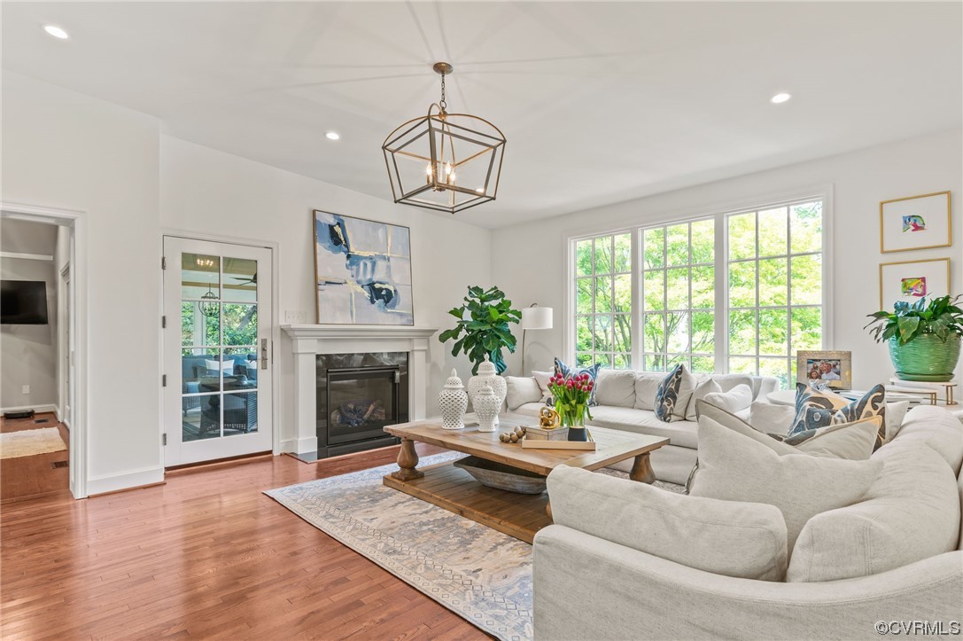 8908 Brieryle Road Henrico, VA 23229 - Photo 13 of 50 a living room with furniture a chandelier and a fireplace
