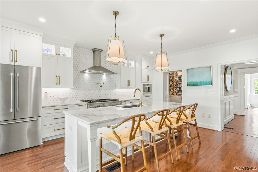 8908 Brieryle Road Henrico, VA 23229 - Photo 17 of 50 a kitchen with stainless steel appliances kitchen island granite countertop a stove a refrigerator and a wooden floor