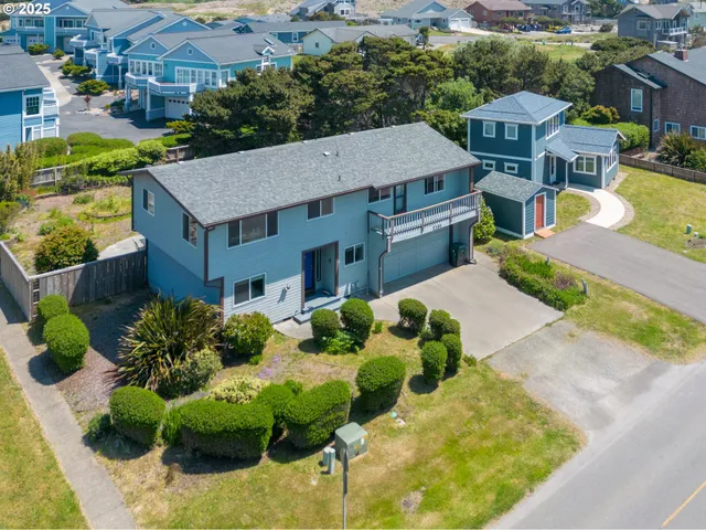 an aerial view of a house with a yard and potted plants