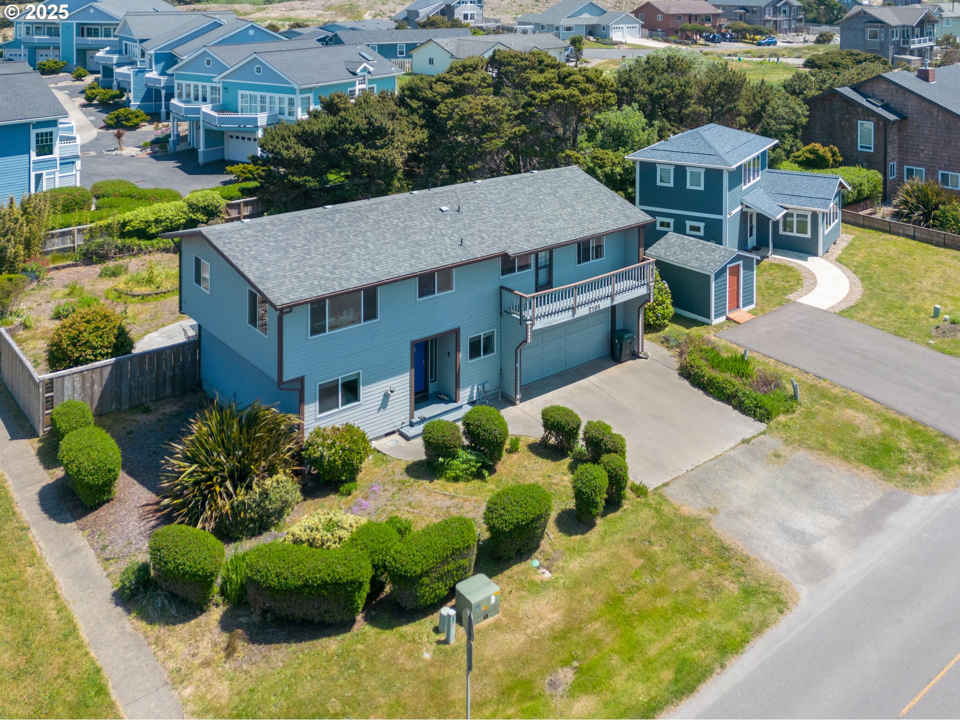 an aerial view of a house with a yard and potted plants