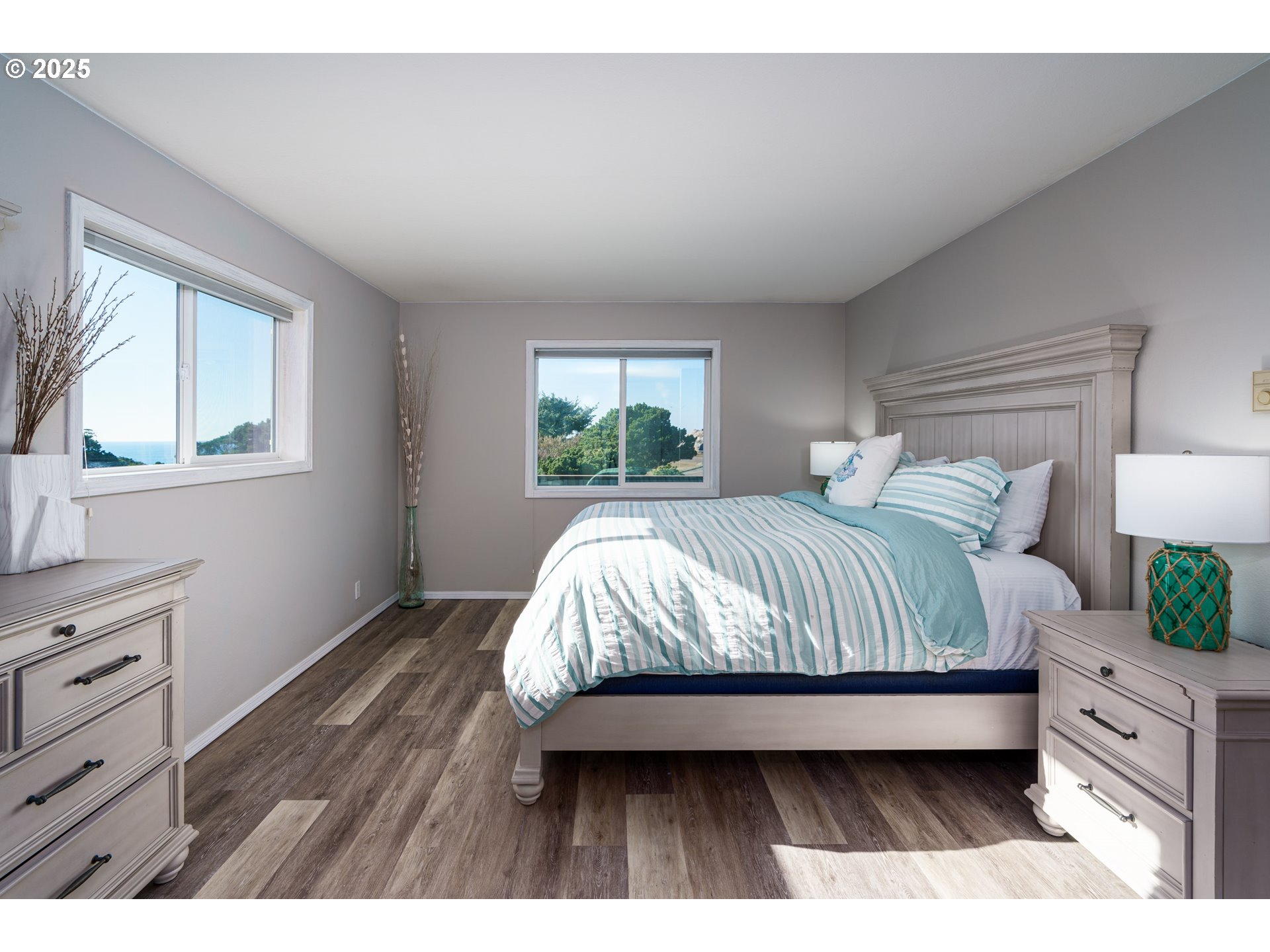 2131 Beach Loop Road Bandon, OR 97411 - Photo 14 of 32 a bedroom with a large bed and a window