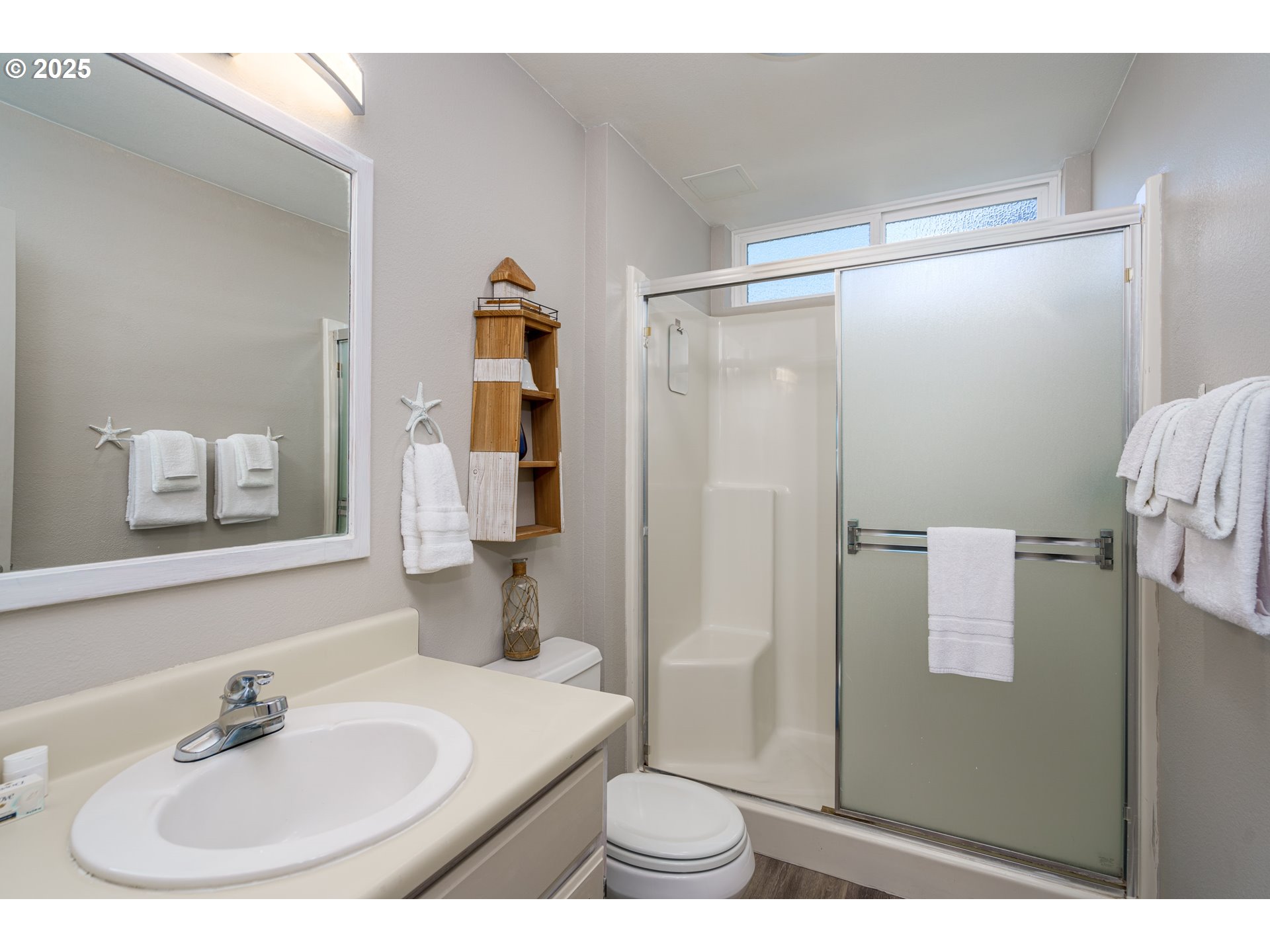2131 Beach Loop Road Bandon, OR 97411 - Photo 26 of 32 a bathroom with a sink and mirror