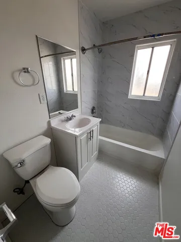 a bathroom with a sink toilet and mirror