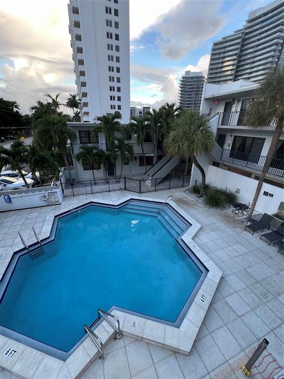 2100 Northeast 33rd Avenue, Unit S A Fort Lauderdale, FL 33305 - Photo 8 of 12 a view of a swimming pool with outdoor seating