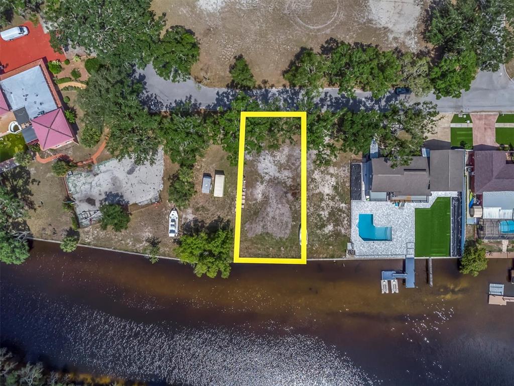 Flotilla Holiday, FL 34690 - Photo 13 of 19 a front view of a house with a yard and garage