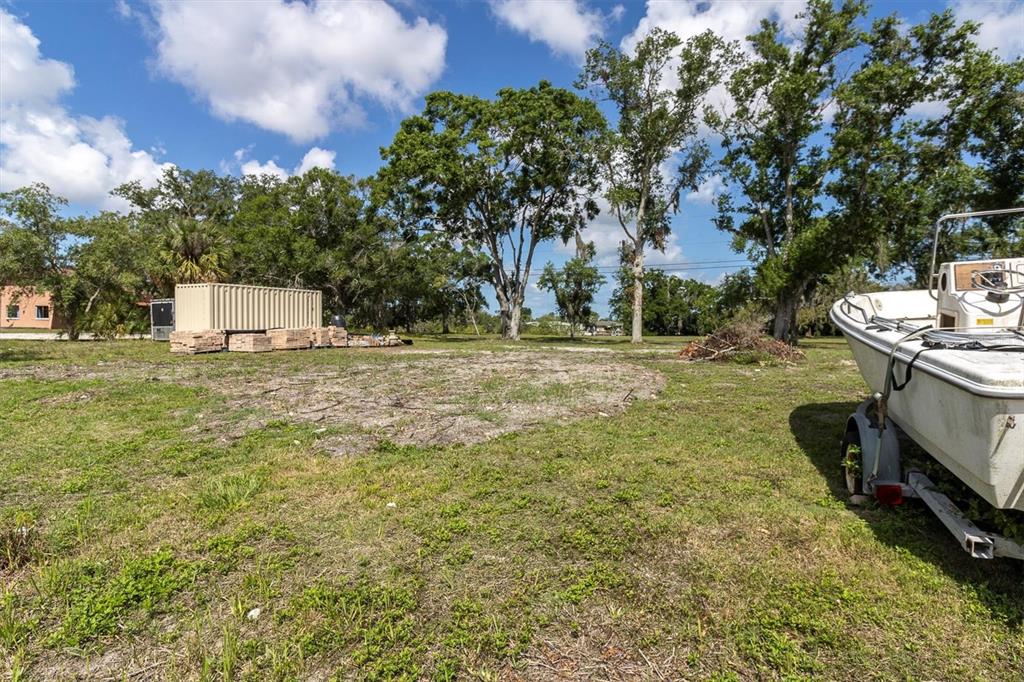 Flotilla Holiday, FL 34690 - Photo 8 of 19 a view of a white house with a yard and sitting area