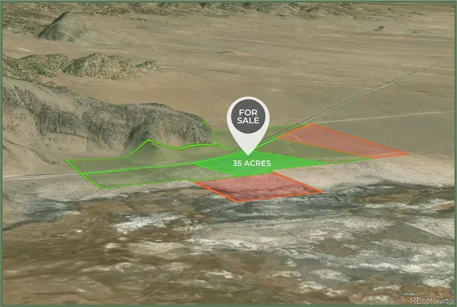 a view of a dry yard with mountains in the background