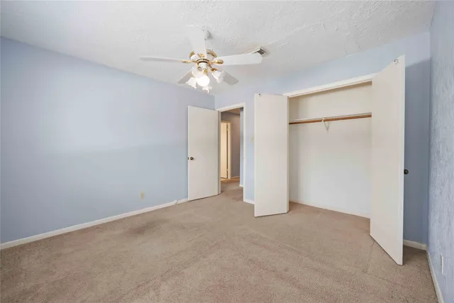 a view of an empty room with a fan