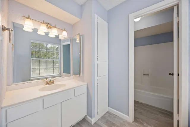 a bathroom with a sink double vanity and a large mirror