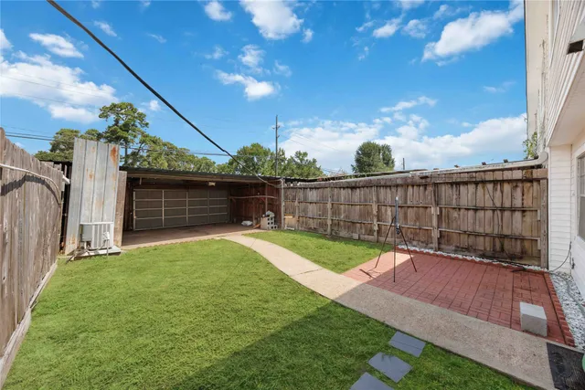 a view of a backyard with sitting area