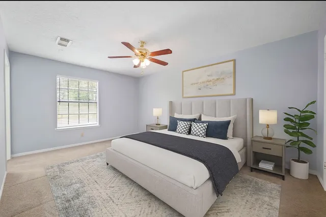 a spacious bedroom with a bed and a window