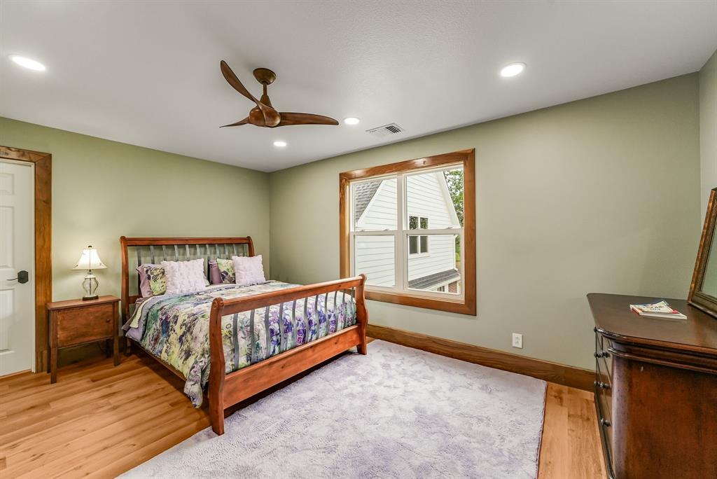 1037 Harrison Road Denison, TX 75021 - Photo 27 of 39 Bedroom #4 on second floor featuring wood-finish flooring, a contemporary ceiling fan, recessed lighting, a large window with natural wood trim, and a paneled door with matching wood trim