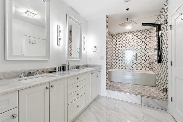 a bathroom with a double vanity sink mirror and shower